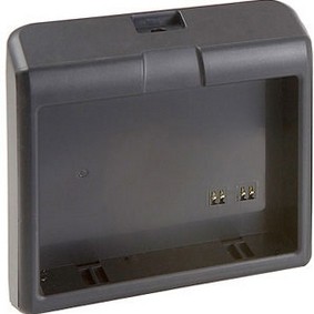 Black plastic battery charger with a rectangular shape, featuring two metal contacts inside for charging and a slot on top for battery insertion.