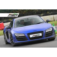 Blue Audi R8 V10 sports car on a track, with PSR Experience branding on the front license plate.