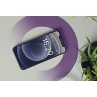 Smartphone displaying 16:20 on screen, surrounded by a purple circle, next to green plants.