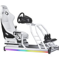 White Thermaltake gaming chair with black accents, steering wheel, gear shift, pedals, and RGB lighting on the base.