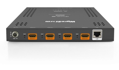 WyreStorm NHD-124-TX video encoder in a sleek black metal casing, featuring four HDMI ports with orange accents and a LAN port on the side for connectivity.