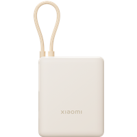 Tan Xiaomi 33W power bank with integrated cable, compact square design, and subtle logo on the front.