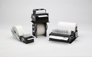 Three Zebra Z-Select 2000D label rolls in varying sizes, featuring white paper labels, black plastic holders, and a sleek, modern design suitable for printing applications.