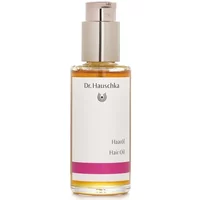 Clear bottle of Dr Hauschka Hair Oil 75ml with silver pump and pink label accent.