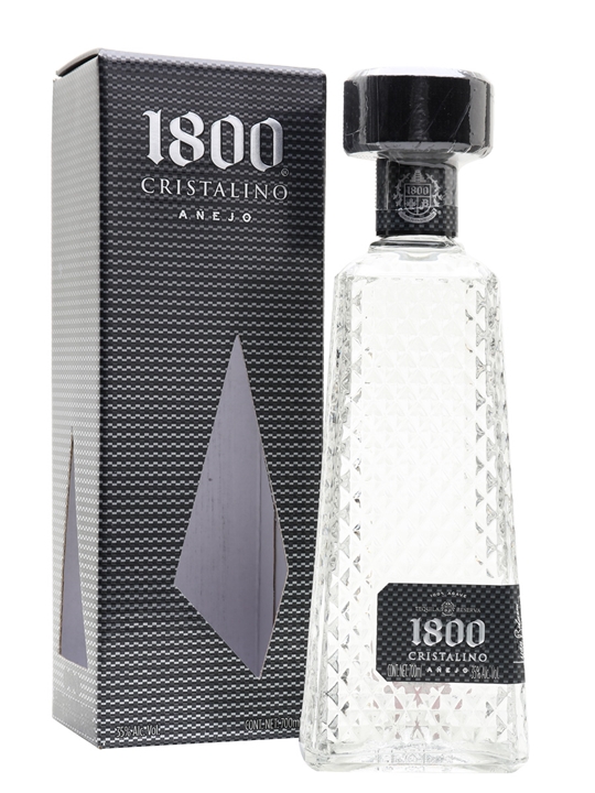 Clear glass bottle with a diamond-patterned design, topped with a black cap, alongside a sleek black box featuring silver accents and the label "1800 Cristalino Anejo Tequila, 70 Cl."