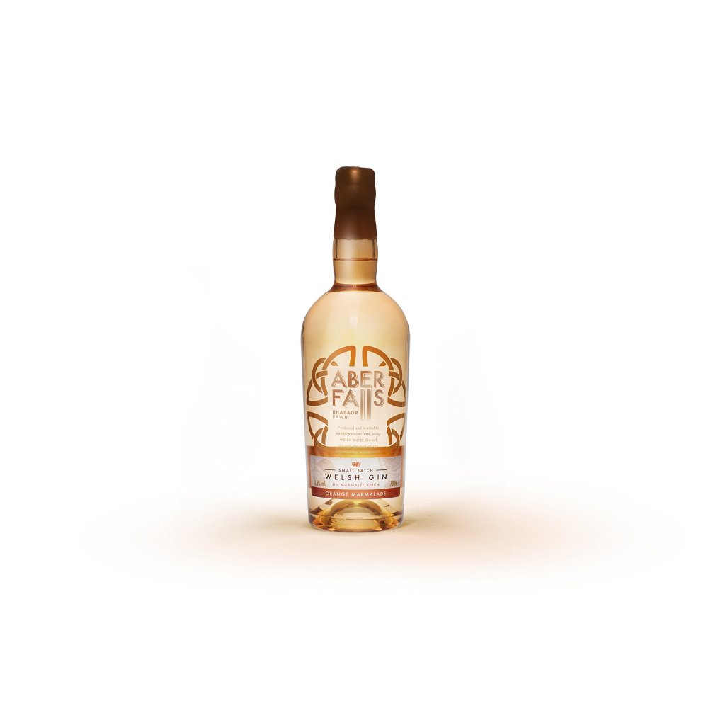 Clear glass bottle of Aber Falls Orange Marmalade Gin, featuring a gold and white label, a cork stopper, and a decorative sun emblem, containing 70 cl of gin.