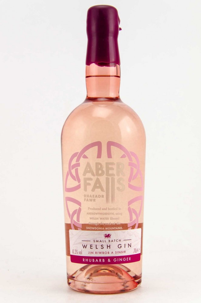 Clear glass bottle of Aber Falls Rhubarb and Ginger Gin, featuring a pink liquid, a pink and white label with intricate designs, and a pink cap, labeled as 70 Cl and 41.3% ABV.