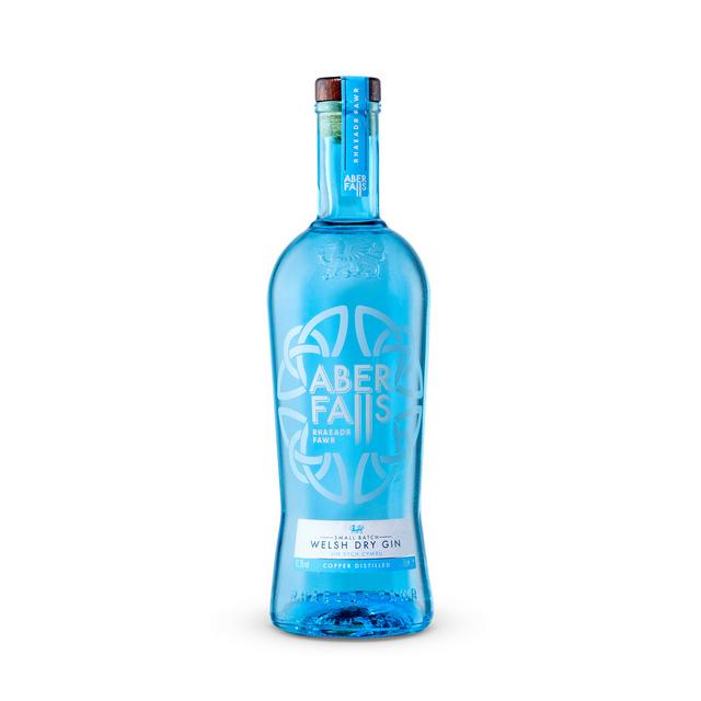 Clear blue glass bottle of Aber Falls Welsh Dry Gin, featuring a white floral design, a cork stopper, and a label displaying "70 Cl" and "Welsh Dry Gin."