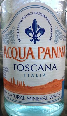 Clear glass bottle of Acqua Panna Still Mineral Water, featuring a blue and white label with a fleur-de-lis, showcasing "TOSCANA ITALIA" and "NATURAL MINERAL WATER" text.