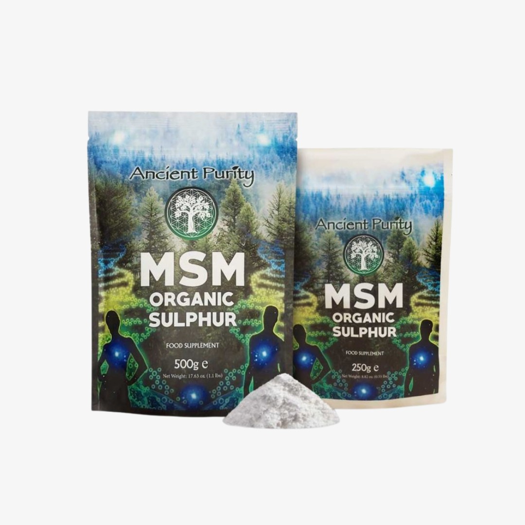 Two bags of Ancient Purity MSM Organic Sulphur, one 500g and one 250g, featuring a forest design and vibrant colors, with a pile of white powder in front.