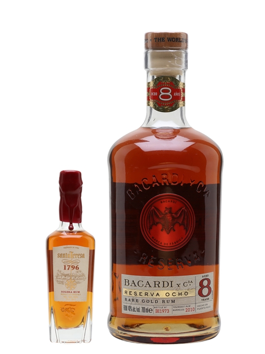 Amber-colored Bacardi 8 Year Old Reserva Ocho Rum in a tall glass bottle with a cork stopper, featuring a prominent red and gold label, alongside a smaller bottle of Santa Teresa 1796 Rum.