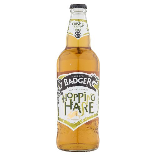 Eight bottles of Badger Hopping Hare Pale Ale, each 500 ml, featuring a clear glass design, golden amber liquid, and a prominent label with green and white accents.