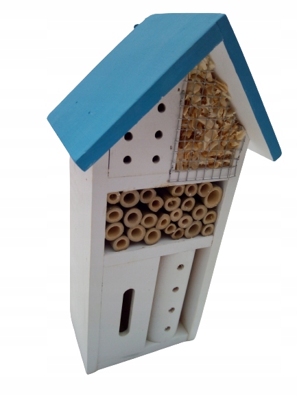 A wooden insect hotel shaped like a house, featuring a blue roof and white walls, with various tubes and natural materials for sheltering insects.