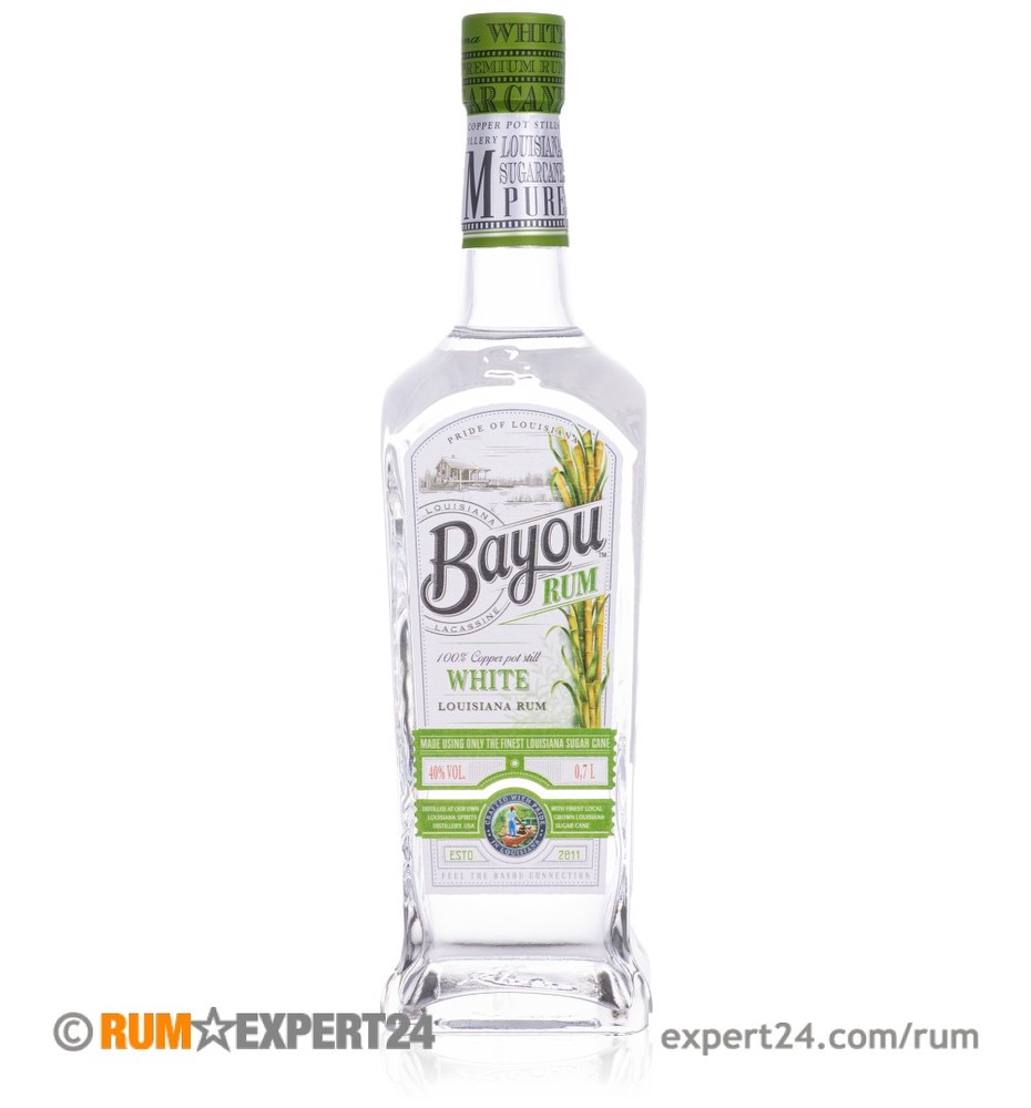Clear glass bottle of Bayou White Rum, featuring a green and white label with sugarcane imagery, a green cap, and a distinctive square shape, holding 70 cl of rum.