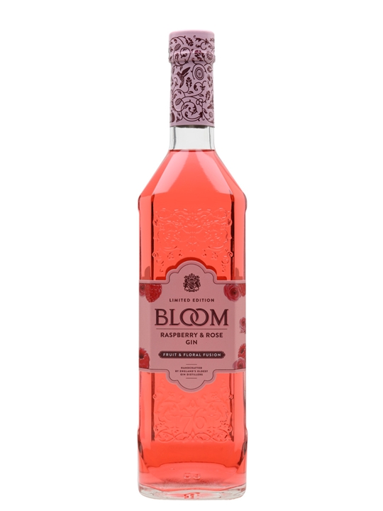 Clear glass bottle filled with pink raspberry and rose gin, featuring an ornate embossed design and a floral-patterned purple cap, labeled "BLOOM Limited Edition."