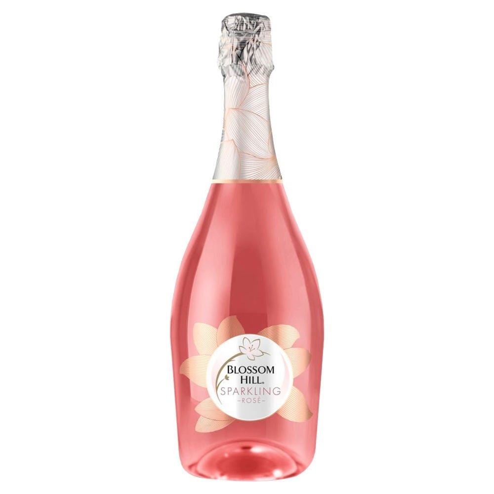 Blossom Hill Sparkling Rosé Wine in a clear glass bottle with a pink liquid, featuring a floral design and a silver foil cap, labeled prominently with "Blossom Hill Sparkling Rosé."
