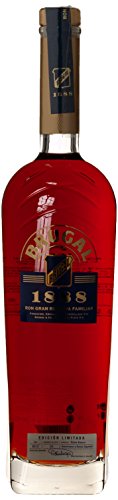 Brugal 1888 Rum in a tall, elegant glass bottle with a deep amber color, gold accents, and a blue label featuring the brand name and vintage year.