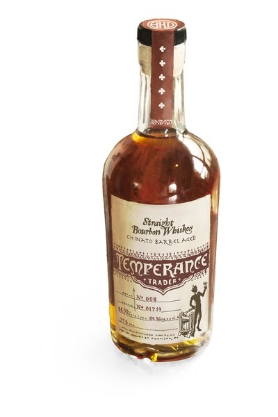 A clear glass bottle of Bull Run Distilling Co. Barrel Strength Straight Bourbon Whiskey, featuring a brown liquid, a cork stopper, and a vintage-style label with detailed text and graphics.