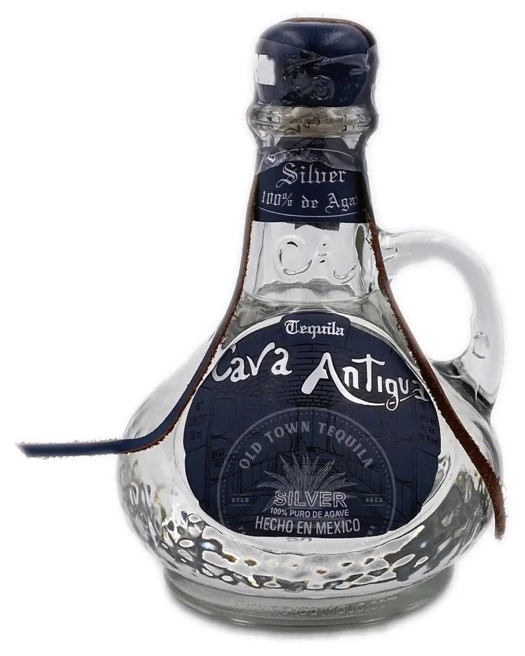 Clear glass bottle with a rounded base and a narrow neck, featuring a blue and silver label that reads "Cava Antigua Silver Tequila," adorned with a brown leather strap.