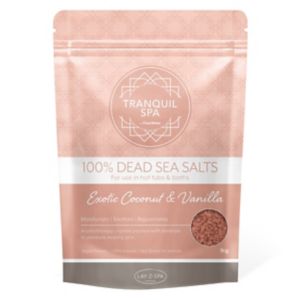 Pink resealable pouch labeled "Tranquil Spa 100% Dead Sea Salts" with "Exotic Coconut & Vanilla" in white text, featuring a clear window showing the salt inside.