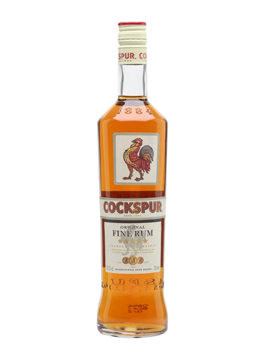 Clear glass bottle of Cockspur Fine Rum, 70 Cl, featuring a red and gold label with a rooster emblem and a white cap, showcasing amber-colored rum inside.