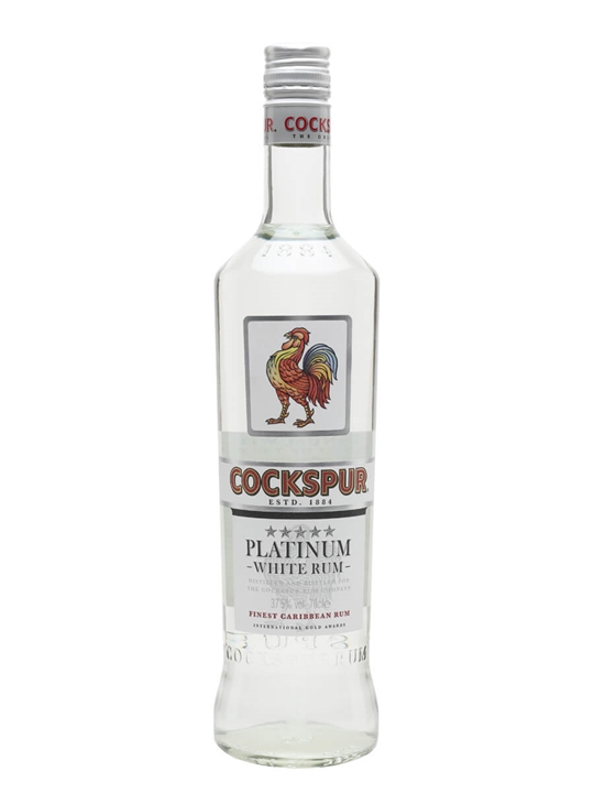 Clear glass bottle of Cockspur Platinum Rum, featuring a colorful rooster label, silver cap, and bold red and blue text, containing 70 cl of fine Caribbean rum.