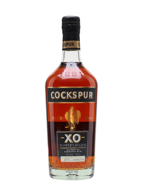 Cockspur XO Dark Rum in a clear glass bottle with a tapered neck, featuring a dark amber liquid, gold and black label, and a rooster emblem, showcasing its premium quality.
