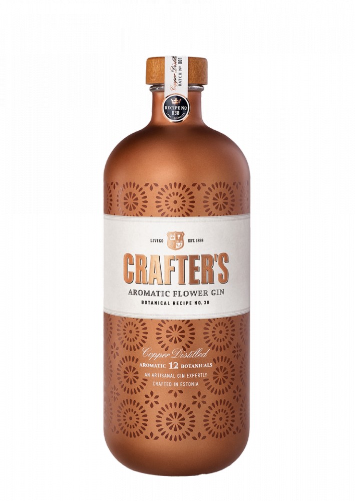 Copper-colored bottle of Crafter's London Aromatic Gin, featuring a white label with decorative cut-out patterns and the brand name prominently displayed.