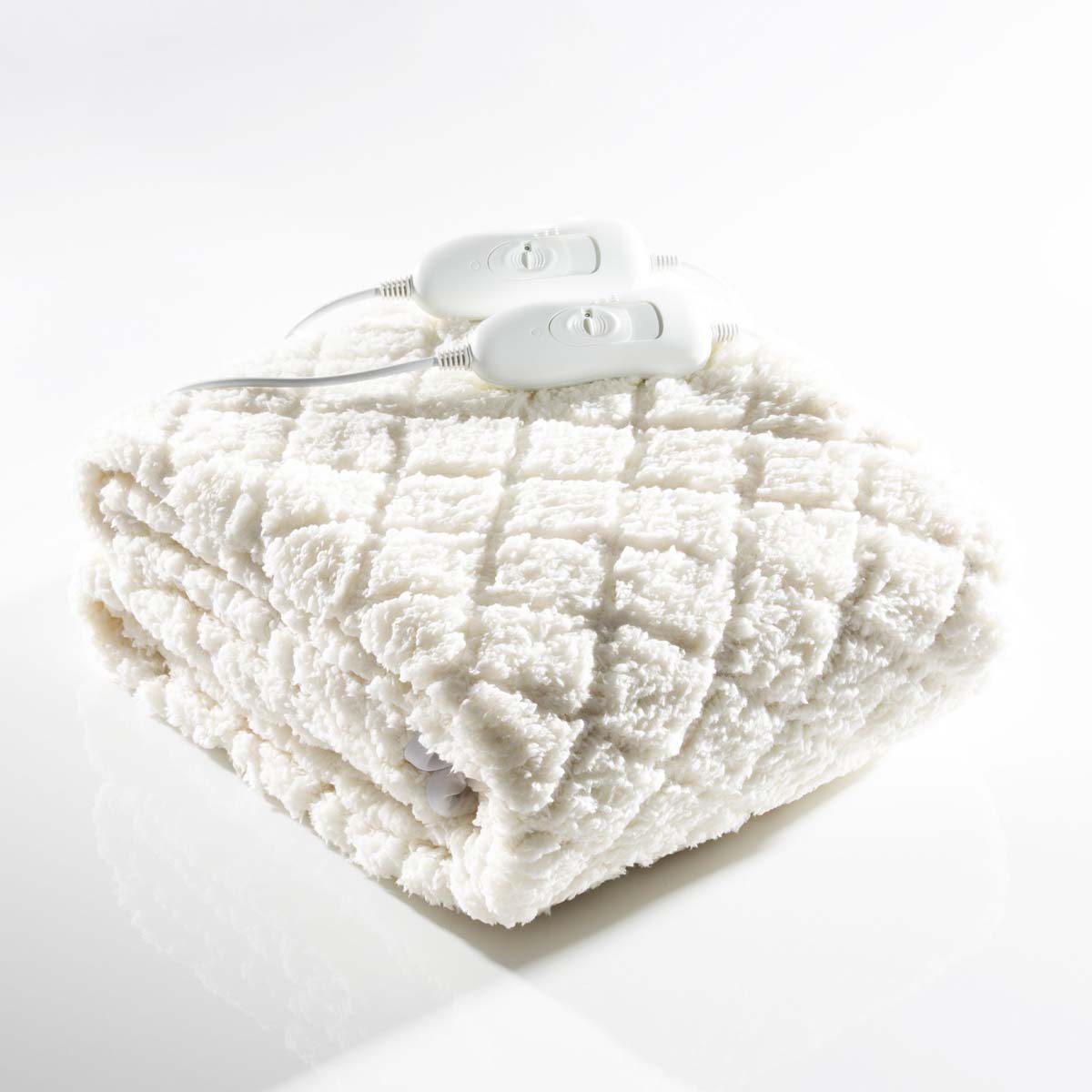 White, king-sized heated underblanket made of soft fleece, featuring a quilted pattern and two white control units for temperature adjustment.