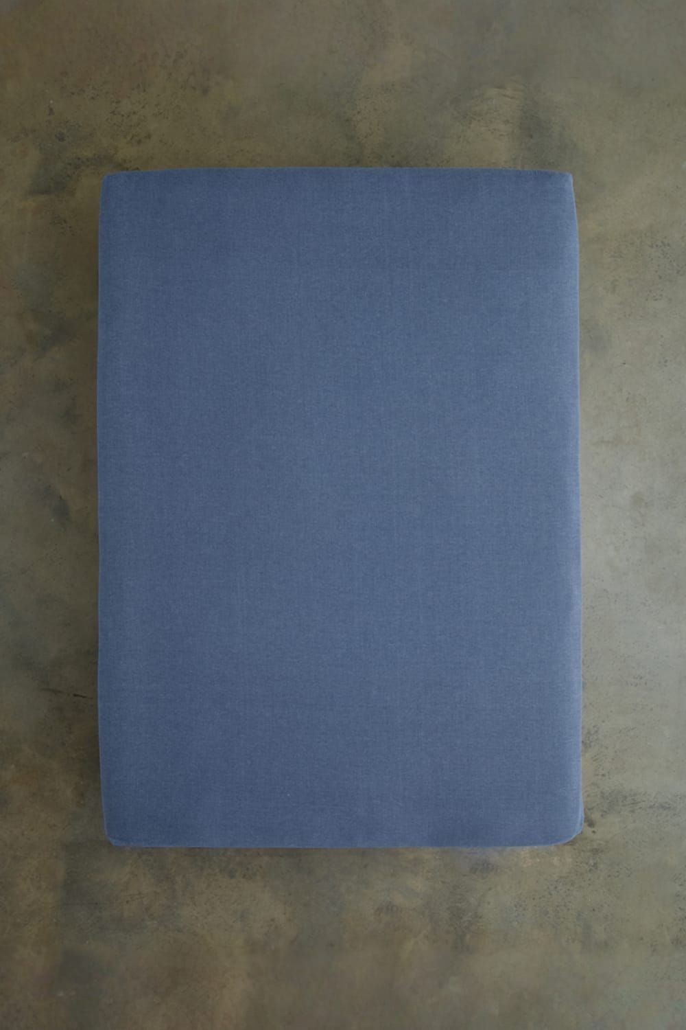 Smooth, soft, and breathable blue fitted sheet by Deyongs, designed for super king size beds, showcasing a melange look for a stylish touch.