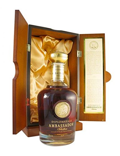 Diplomatico Ambassador Rum in a round, glass bottle with a gold seal, displayed in an elegant wooden box lined with satin, featuring a descriptive card on the inside.