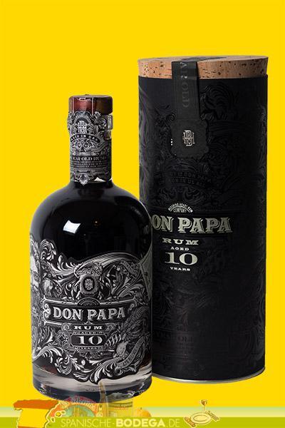 A black bottle of Don Papa 10 Year Old Rum with intricate silver detailing, featuring a cork stopper, displayed alongside a matching cylindrical black box.