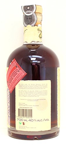 Dark amber bottle of Don Papa 7 Year Old Rum, 70 cl, featuring a textured label, cork stopper, and a red seal, with a detailed back label and barcode.