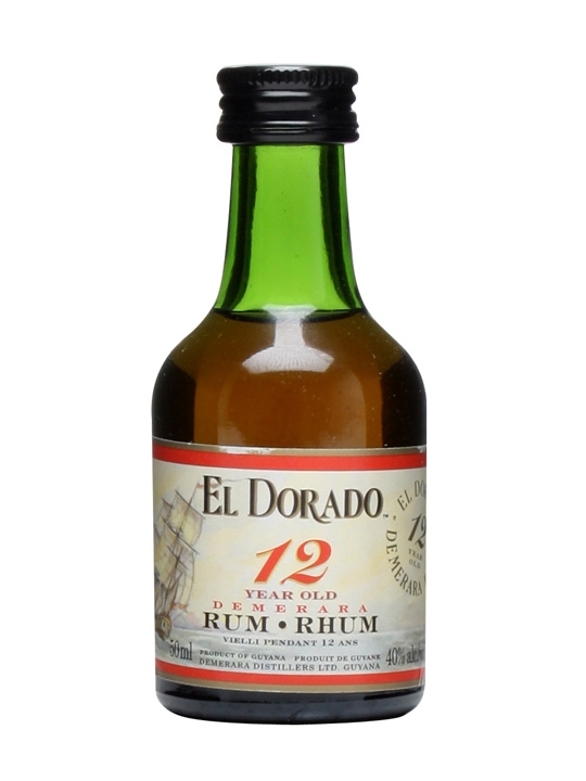 Miniature bottle of El Dorado 12 Year Old Rum, 5 cl, featuring a green glass body, black cap, and a label with a ship illustration and red accents.