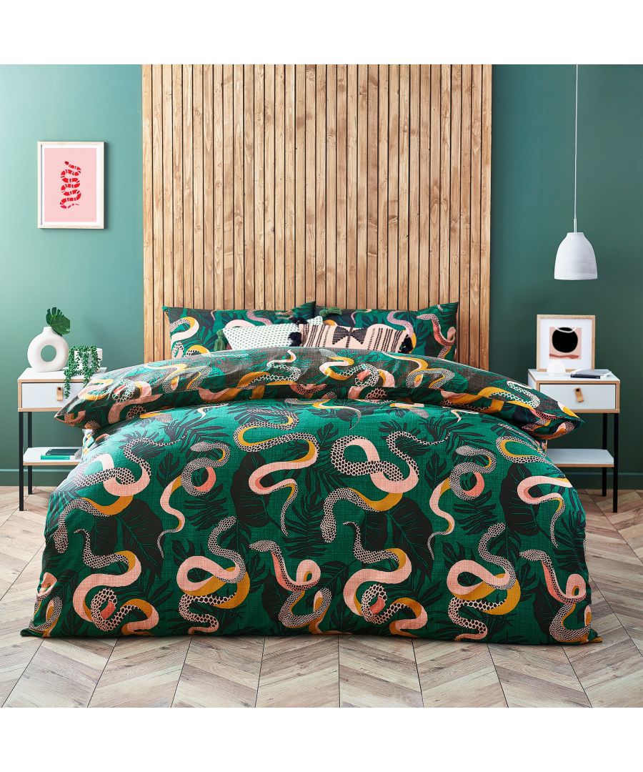 Reversible super king duvet cover set in green cotton featuring a serpentine animal print with vibrant colors and intricate patterns, complemented by a wooden accent wall.