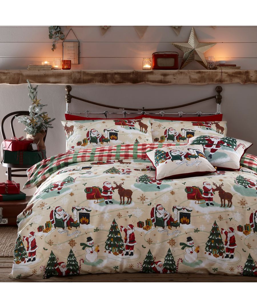 Reversible duvet cover set featuring festive Santa, reindeer, and snowman designs in red, green, and cream, with coordinating plaid accents and decorative pillows.