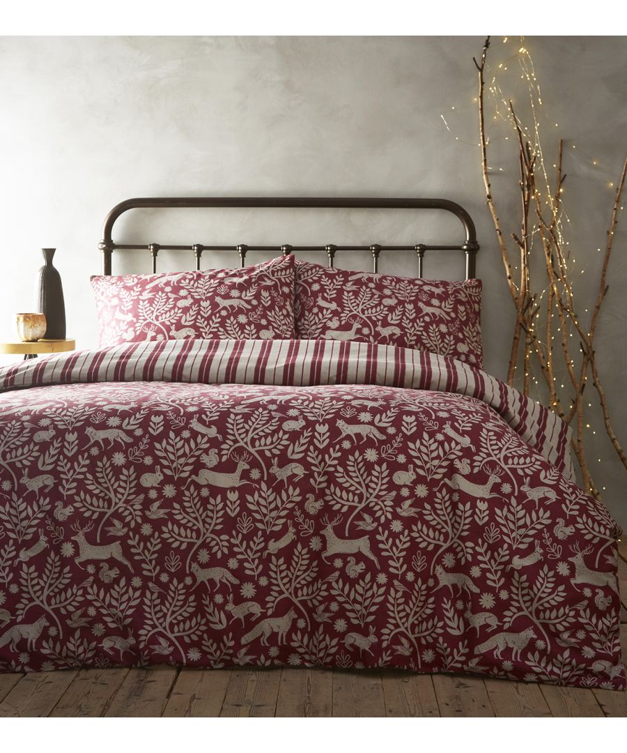Super King duvet cover set in wildberry cotton featuring a woodland animal and floral print, complemented by striped pillowcases, styled on a metal bed frame.
