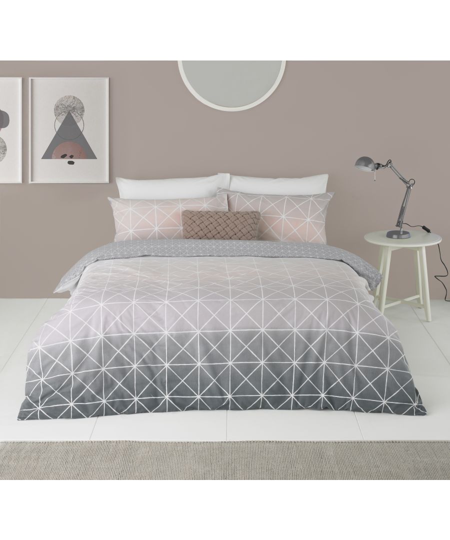 Super King reversible duvet cover set featuring a geometric gradient design in soft pink and gray tones, complemented by matching pillowcases and a textured throw pillow.