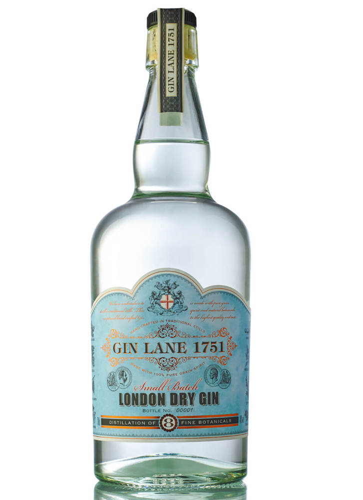Clear glass bottle with a curved shape, featuring a light blue label adorned with ornate designs, stating "Gin Lane 1751 London Dry Gin" in elegant lettering.