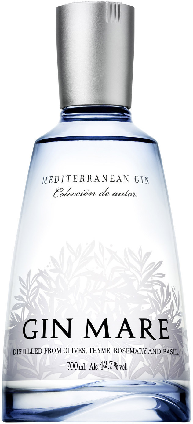 Clear glass bottle of Gin Mare Miniature, 10 Cl, featuring a silver cap, blue label with olive and herb motifs, and text highlighting Mediterranean gin ingredients.