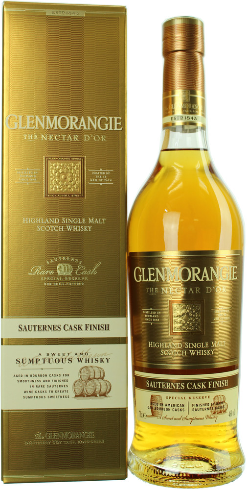 Glenmorangie The Nectar D'or Whisky in a clear bottle with a gold label, featuring elegant text, alongside a matching gold box, showcasing its rich amber color.