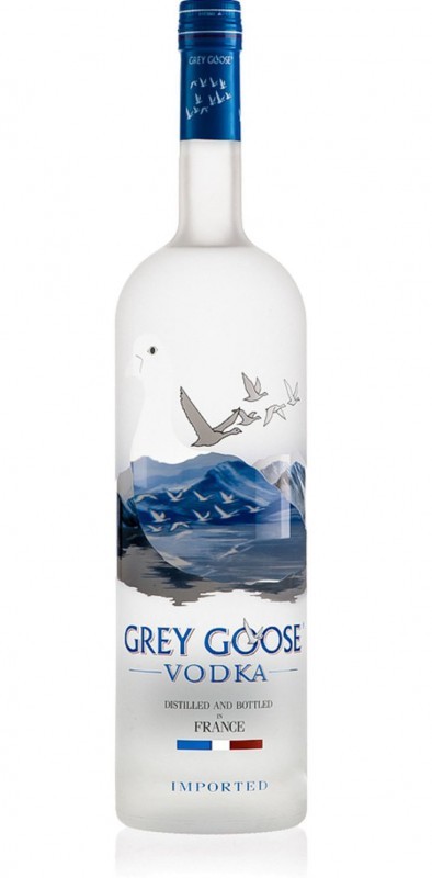 Clear glass bottle of Grey Goose Vodka Methuselah, 6 L, featuring a frosted design with a white goose and blue mountains, labeled with "GREY GOOSE VODKA" in bold letters.