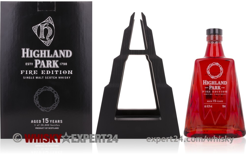 Highland Park Fire 15 Year Old whisky features a striking red bottle with a decorative circular emblem, accompanied by a sleek black display stand and elegant packaging.