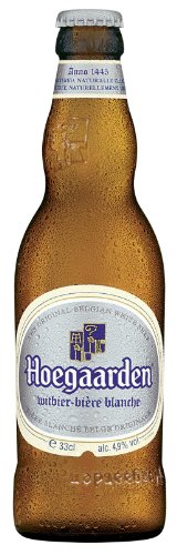 Clear glass bottle of Hoegaarden Wheat Beer, featuring a white label with blue and gold accents, showcasing the brand name and alcohol content, with a golden beer color visible inside.