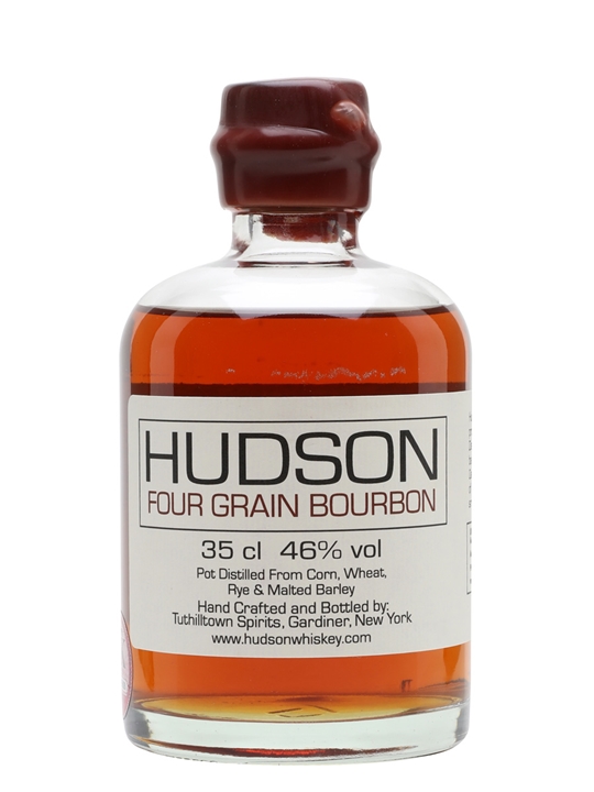 Clear glass bottle containing amber-colored Hudson Four Grain Bourbon, labeled with bold black text, 35 cl, 46% vol, and details about distillation and origin.