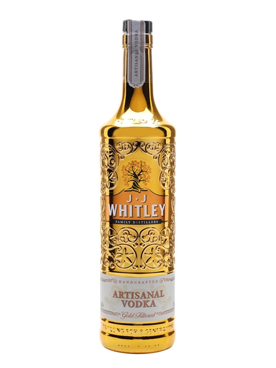 Shiny gold bottle of J.J. Whitley Artisanal Gold Vodka, featuring intricate floral engravings and a white label with the brand name and product details.