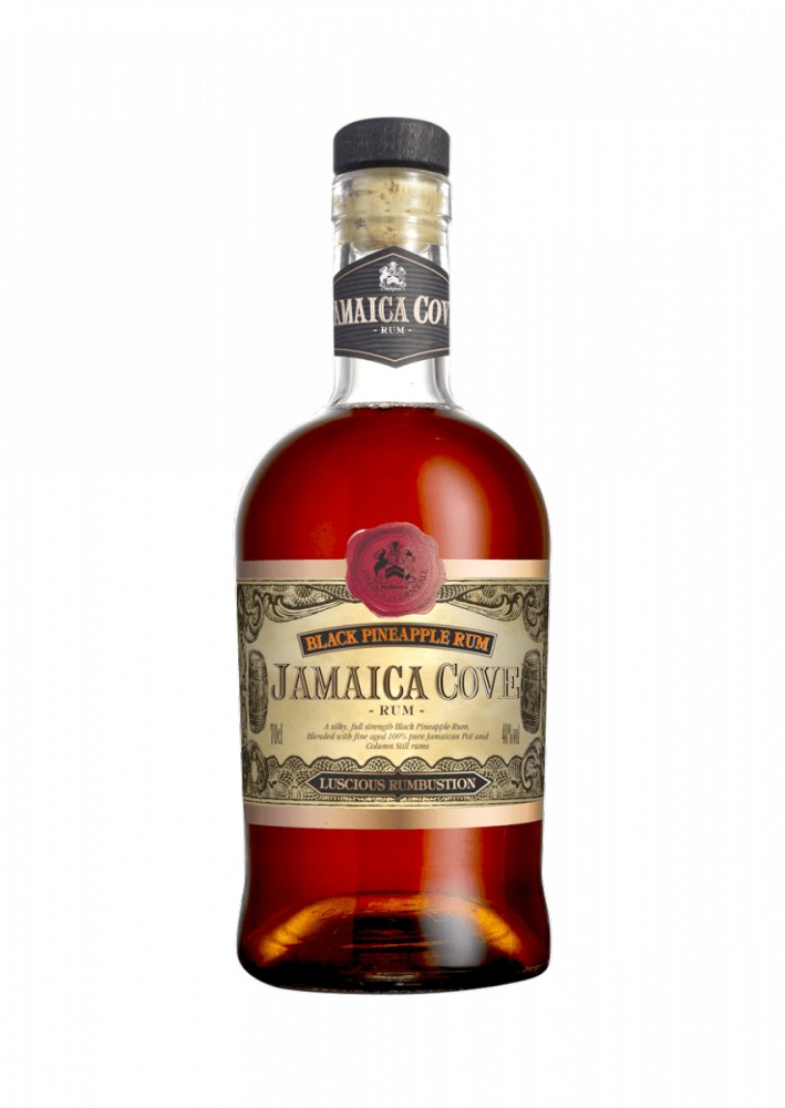 Clear glass bottle of Jamaica Cove Pineapple Rum, featuring a dark amber liquid, ornate label with gold accents, and a cork stopper.