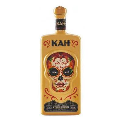 Golden skull-shaped bottle with intricate colorful floral designs and a painted face, labeled "KAH Tequila Reposado 750ml" in bold black lettering.
