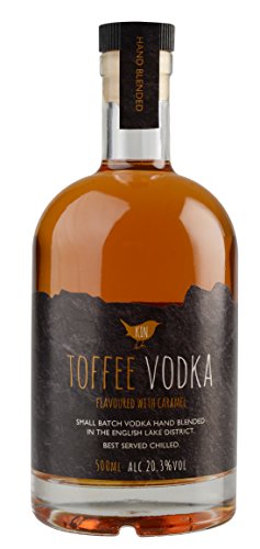 Clear glass bottle filled with amber toffee vodka, featuring a black label with gold text, and a wooden cork stopper.