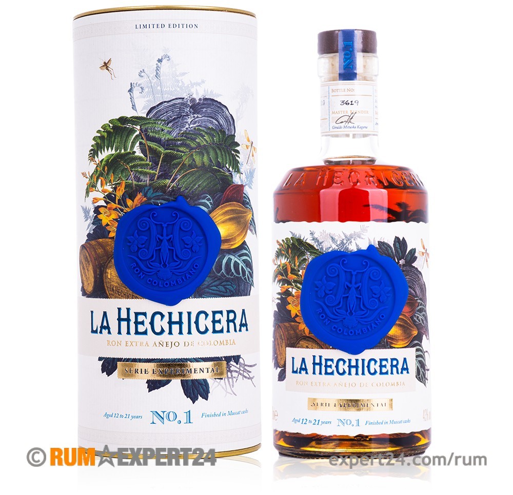La Hechicera Serie Experimental No.1 Muscat Cask Finish Rum in a clear glass bottle with a blue wax seal, presented in a decorative cardboard tube featuring botanical illustrations.